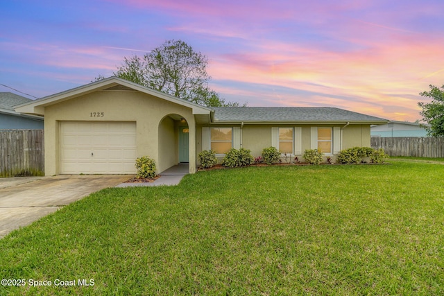 single story home featuring fence, an attached garage, stucco siding, concrete driveway, and a lawn