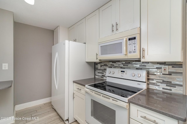 kitchen with tasteful backsplash, baseboards, light wood-type flooring, white cabinets, and white appliances