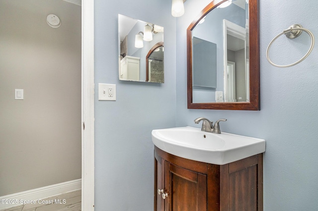 bathroom featuring baseboards and vanity