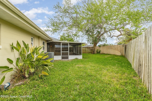 view of yard with a fenced backyard and a sunroom