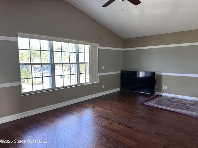 unfurnished room with vaulted ceiling, dark hardwood / wood-style floors, and ceiling fan