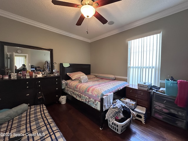 bedroom featuring dark hardwood / wood-style flooring, ornamental molding, and a textured ceiling