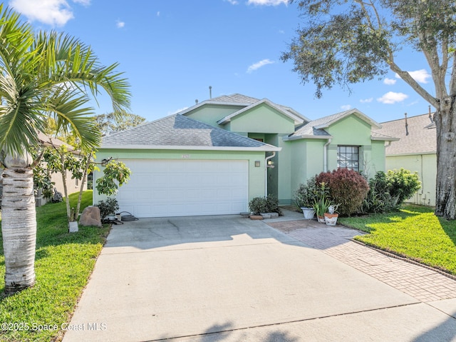 view of front of home with a garage and a front yard