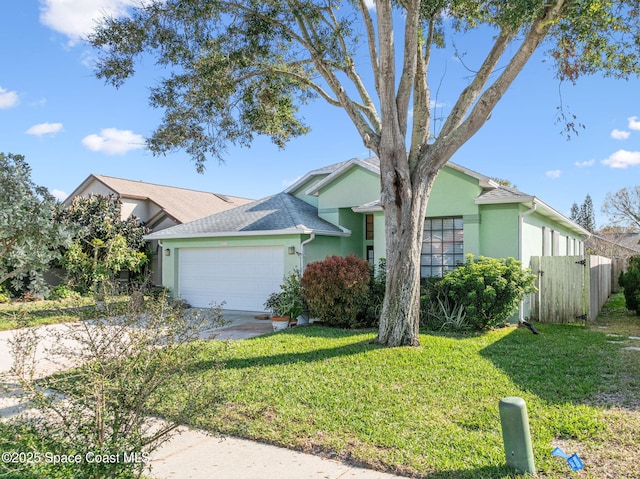 single story home with a garage and a front lawn