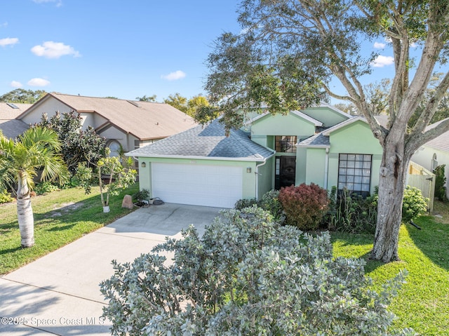 view of front of home with a garage and a front lawn