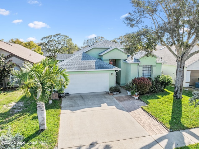 view of front of property featuring a garage and a front lawn