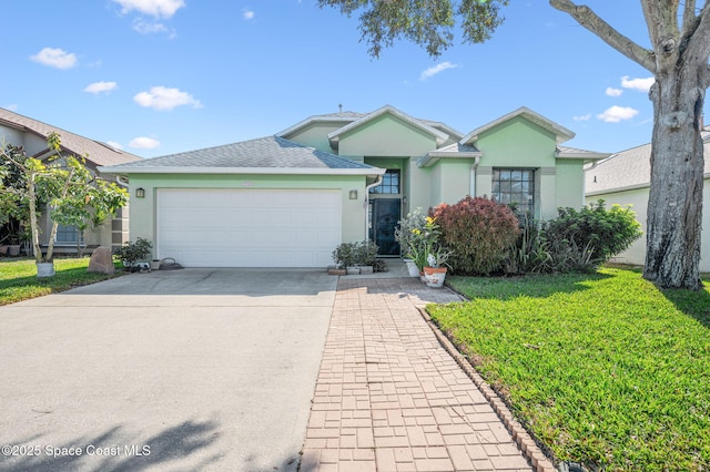 ranch-style home featuring a garage and a front lawn