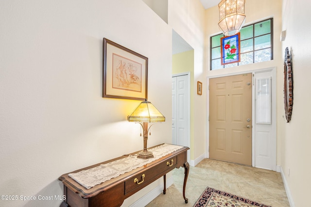 entryway featuring a towering ceiling