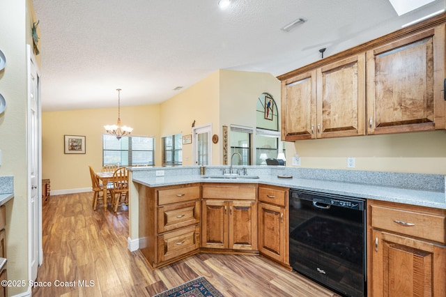 kitchen featuring sink, light hardwood / wood-style flooring, dishwasher, an inviting chandelier, and vaulted ceiling