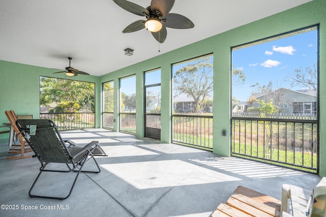 sunroom featuring ceiling fan