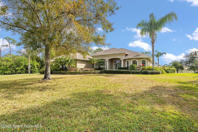 mediterranean / spanish-style home featuring a front lawn