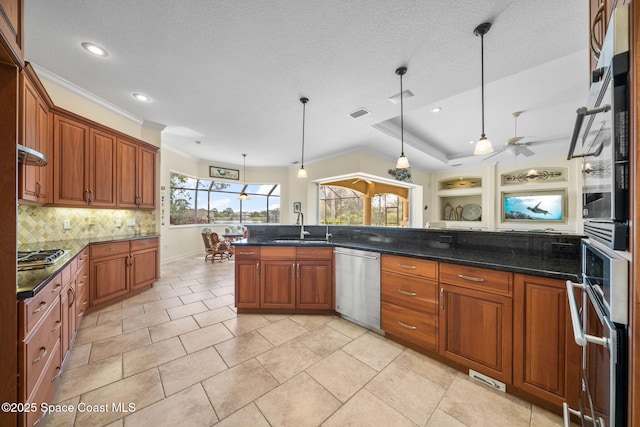 kitchen featuring dark stone countertops, decorative backsplash, hanging light fixtures, stainless steel appliances, and a textured ceiling