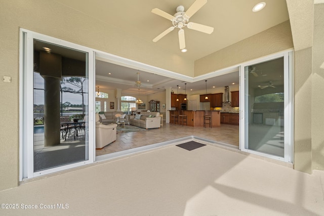 view of patio / terrace with ceiling fan and a bar