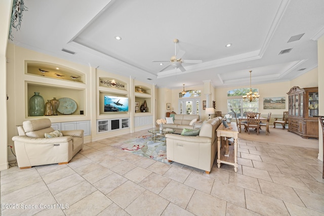 living room featuring light tile patterned floors, built in features, ornamental molding, ceiling fan with notable chandelier, and a raised ceiling