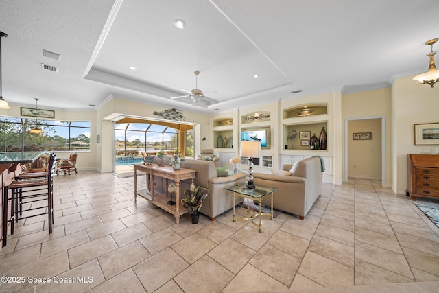 living room featuring a tray ceiling, built in features, ceiling fan, and light tile patterned flooring