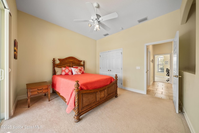 carpeted bedroom featuring a closet and ceiling fan