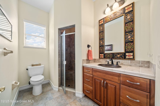 bathroom featuring vanity, toilet, and walk in shower