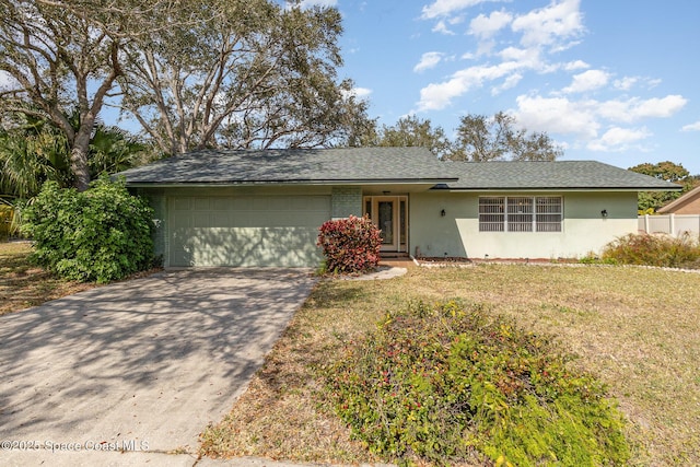 single story home featuring a garage and a front yard