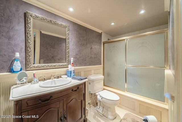 full bathroom with toilet, ornamental molding, vanity, and bath / shower combo with glass door