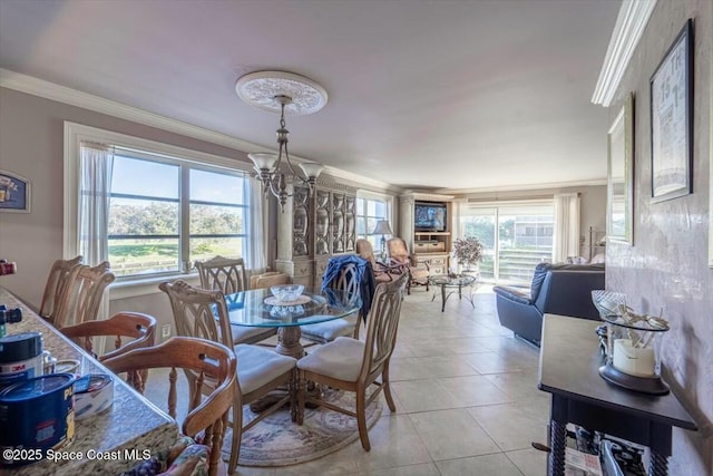 dining area with light tile patterned floors, crown molding, and a notable chandelier