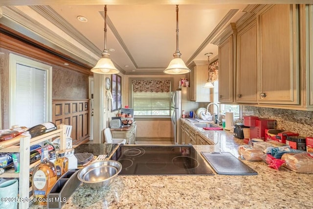 kitchen with crown molding, black electric cooktop, decorative light fixtures, and sink