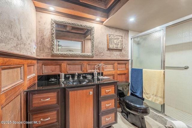 bathroom with a shower with door and sink