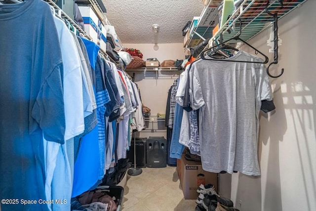 spacious closet with light tile patterned floors