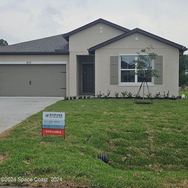 view of front facade with a garage and a front lawn