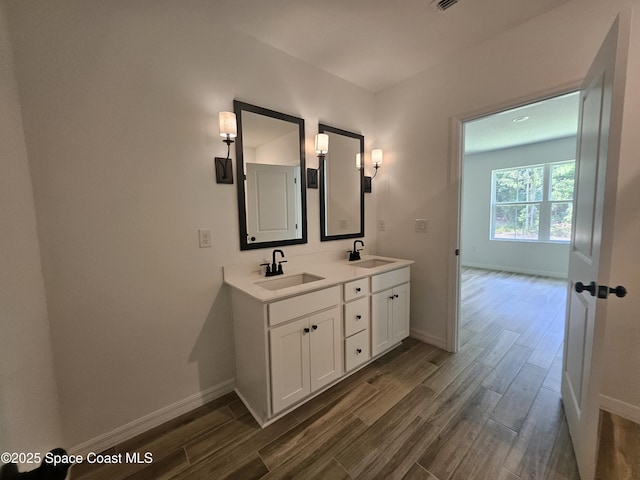 bathroom with hardwood / wood-style flooring and vanity