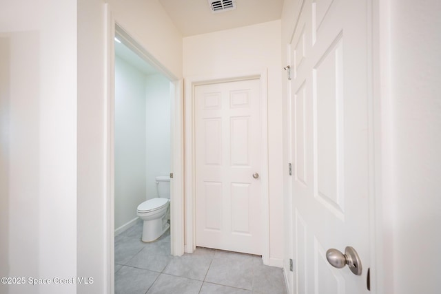 bathroom featuring toilet and tile patterned flooring