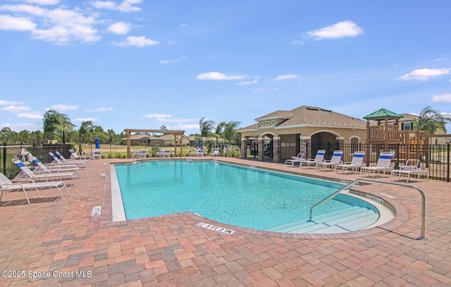 view of swimming pool featuring a pergola and a patio