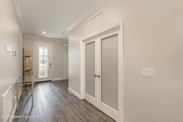 foyer entrance with wood-type flooring and ornamental molding