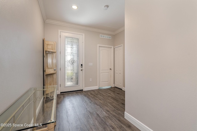 foyer with ornamental molding and dark hardwood / wood-style flooring