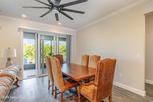 dining space featuring crown molding, dark wood-type flooring, and ceiling fan