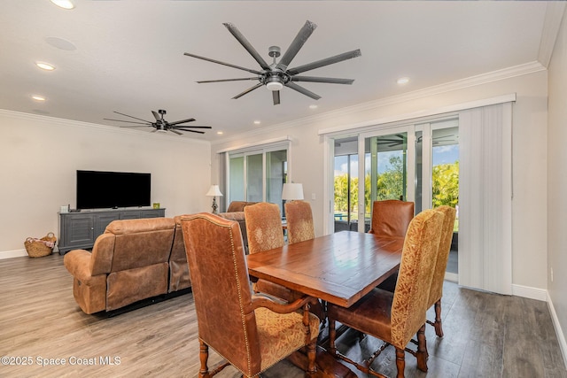 dining room featuring crown molding, ceiling fan, and light wood-type flooring