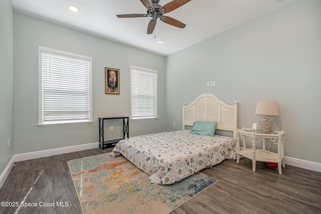 bedroom with dark hardwood / wood-style floors and ceiling fan