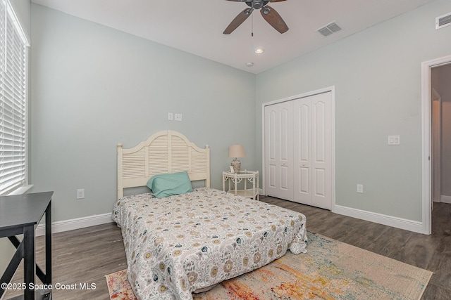 bedroom featuring dark hardwood / wood-style floors, a closet, and ceiling fan