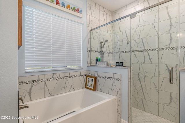 bathroom featuring shower with separate bathtub