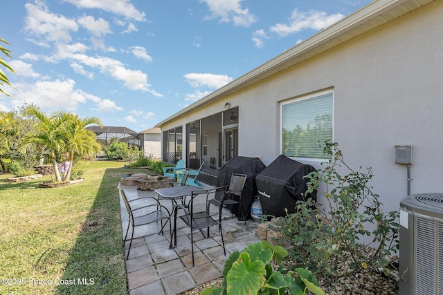 view of patio featuring grilling area, central AC, and an outdoor fire pit