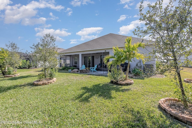 back of house with a patio area and a lawn