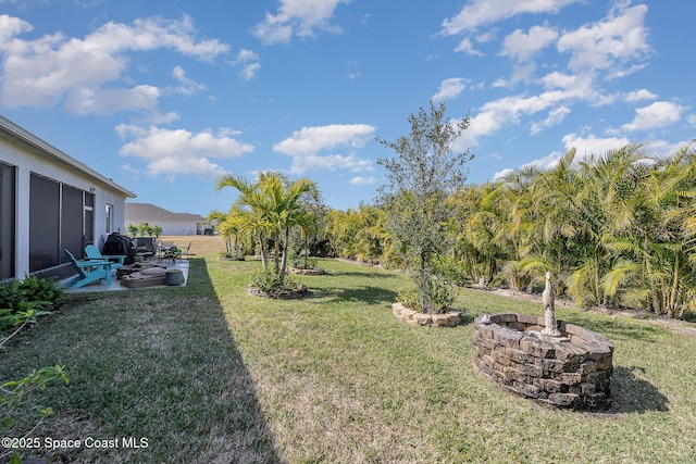 view of yard with a patio area and an outdoor fire pit