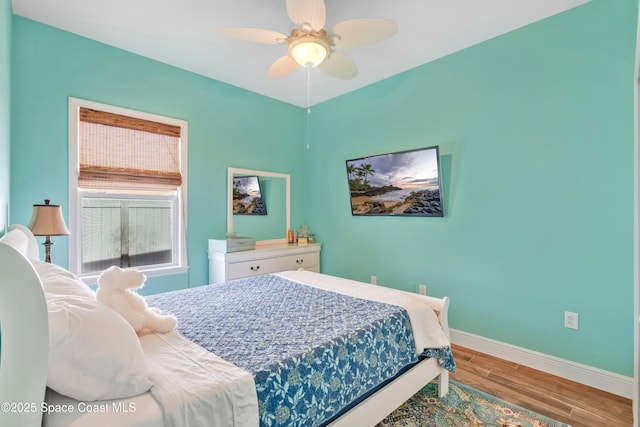 bedroom with hardwood / wood-style flooring and ceiling fan