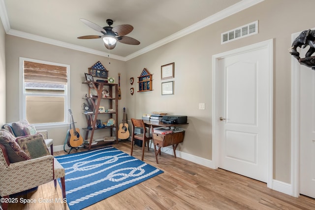 living area with crown molding, ceiling fan, and light hardwood / wood-style flooring