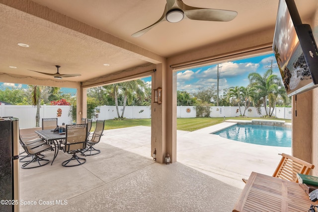 exterior space featuring a fenced in pool and ceiling fan