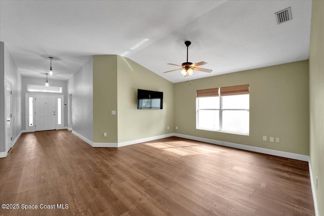 interior space featuring ceiling fan, wood-type flooring, and vaulted ceiling