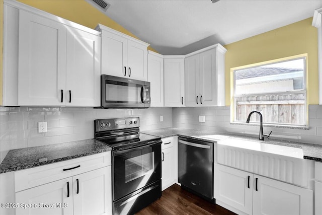 kitchen with sink, white cabinetry, black electric range, stainless steel dishwasher, and dark stone counters