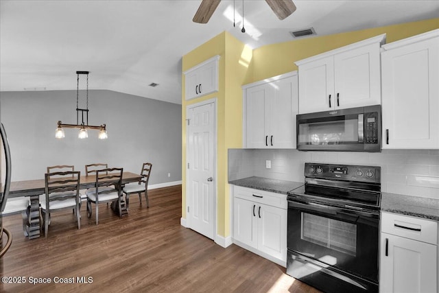 kitchen featuring white cabinetry, decorative light fixtures, black electric range oven, and vaulted ceiling