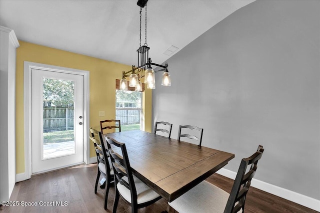 dining area with lofted ceiling and dark hardwood / wood-style floors