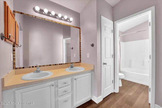 full bathroom featuring vanity, toilet, hardwood / wood-style floors, and shower / bathing tub combination