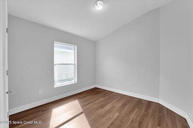 unfurnished room with wood-type flooring